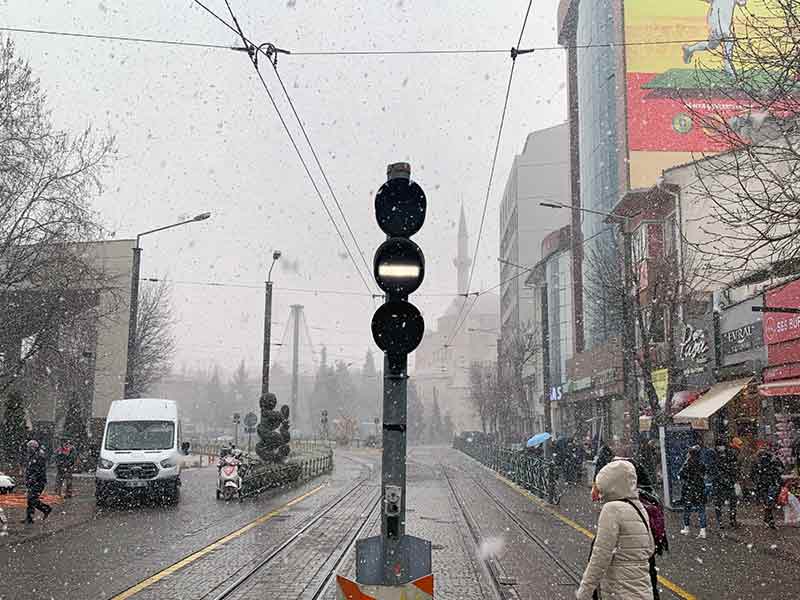 Eskişehir’de öğleden sonra rüzgârla birlikte aniden bastıran yoğun kar yağışı, vatandaşlar arasında şaşkınlıkla karşılanırken, kent merkezinde ilginç görüntüler oluştu.